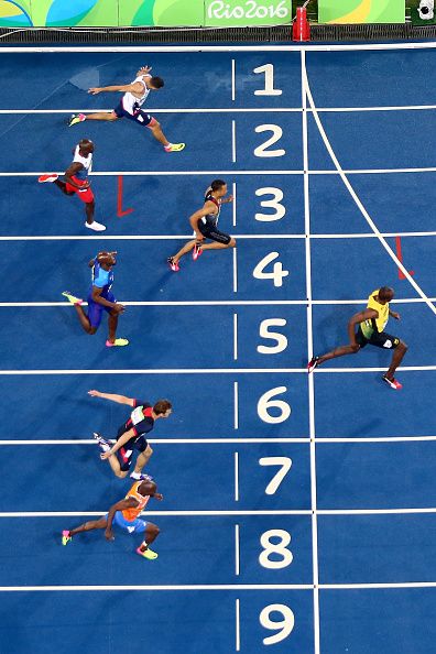 the athletes are competing in a race on the blue track at the olympic games,