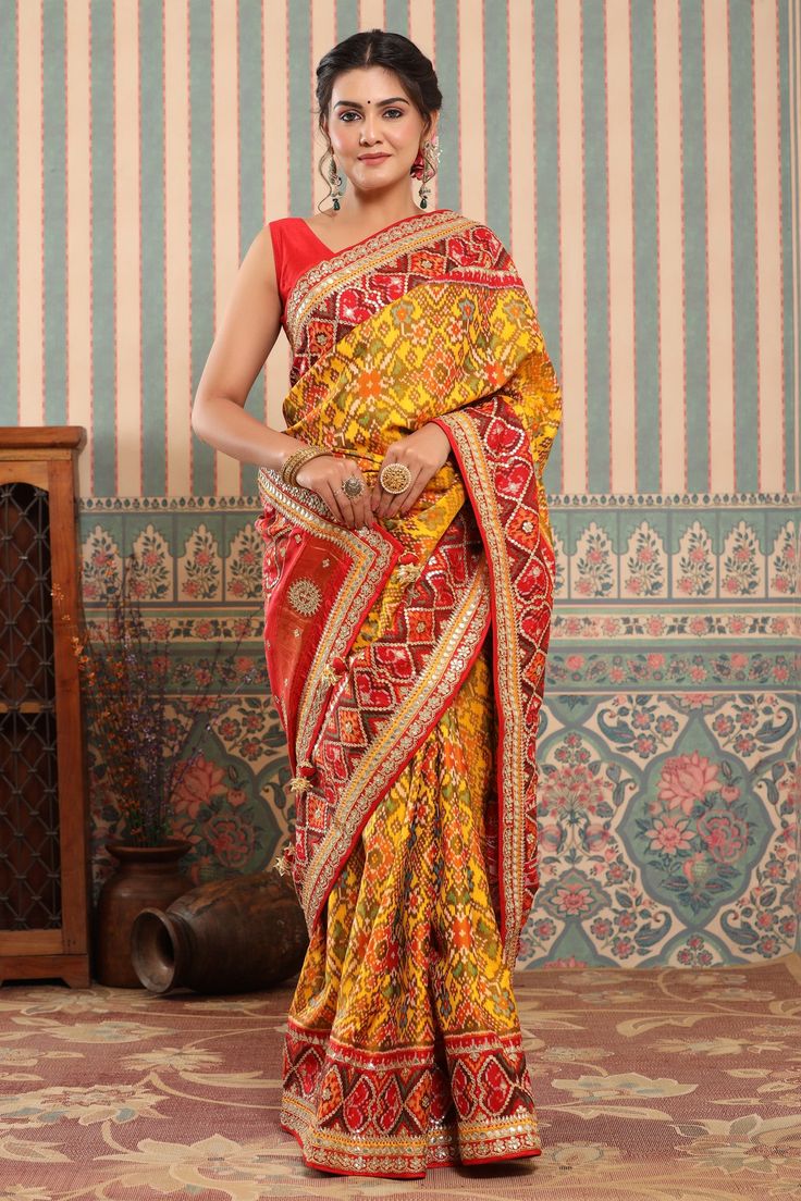 Buy yellow Patola silk sari online in USA with red embroidered border. Make a fashion statement at weddings with stunning designer sarees, embroidered sarees with blouse, wedding sarees, handloom sarees from Pure Elegance Indian fashion store in USA.-full view Yellow Blouse Piece For Navratri, Yellow Semi-stitched Blouse Piece For Traditional Ceremonies, Festive Paithani Silk Pre-draped Saree With Resham Embroidery, Yellow Blouse Piece For Navratri Ceremonies, Anarkali Traditional Wear With Resham Embroidery In Paithani Silk, Anarkali Traditional Wear In Paithani Silk With Resham Embroidery, Yellow Bollywood Blouse Piece For Traditional Ceremonies, Traditional Yellow Blouse Piece With Traditional Drape, Semi-stitched Yellow Blouse Piece For Traditional Ceremonies