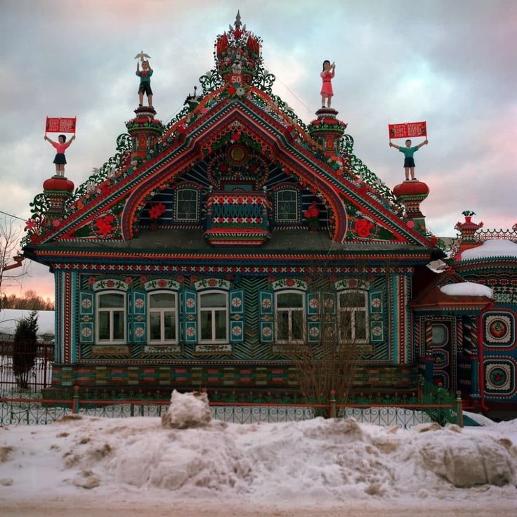 an elaborately decorated house sits in the snow