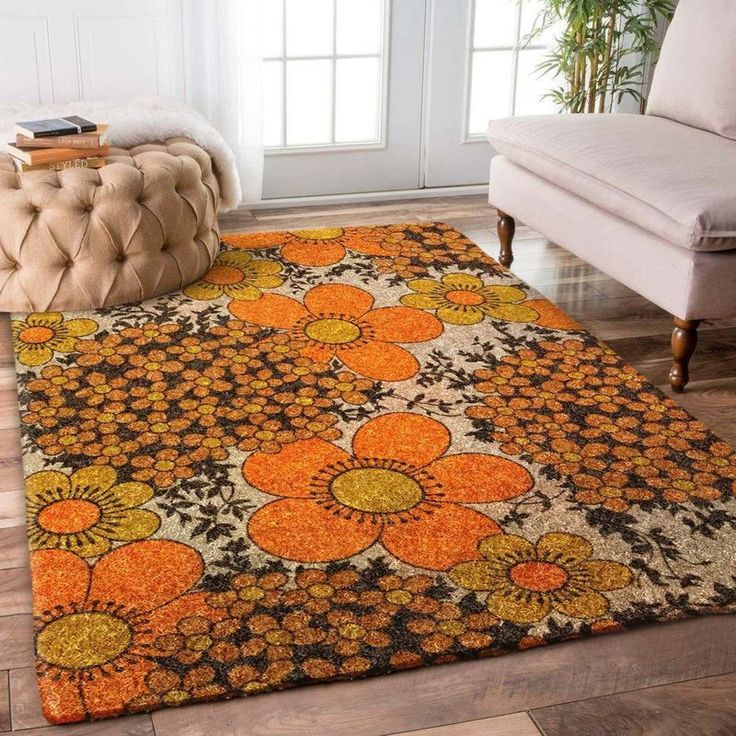 an area rug with orange and yellow flowers on it