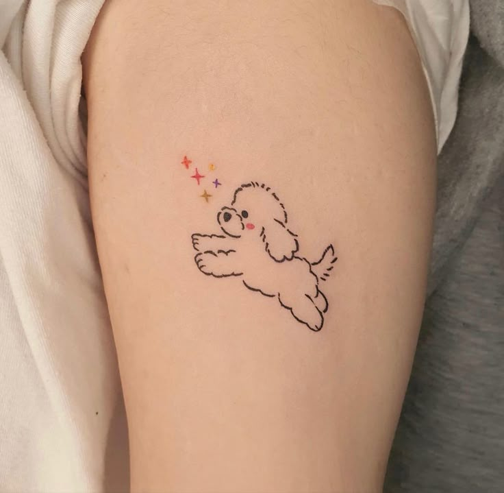 a small dog tattoo on the left thigh and right leg, with stars around it