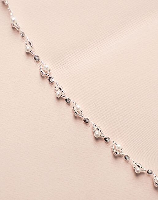 a close up view of a silver chain on a pink background with space for text