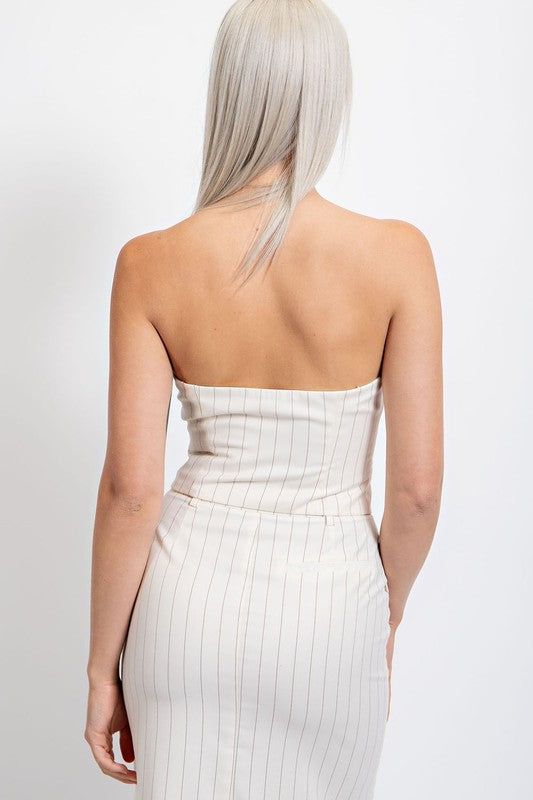 Experience effortless style with our Ivory Pinstripe Strapless Crop Top. Made with a trendy pinstripe design, this top features a functional button-down front and a strapless neckline for a chic look. Perfect for any occasion, pair with high-waisted pants or skirts for a versatile and sophisticated outfit. Fabric & fit: Model is wearing size small. Pinstriping Designs, Strapless Crop Top, Small Crop Tops, Strapless Neckline, Chic Look, High Waisted Pants, Effortless Style, Crop Top, High Waisted