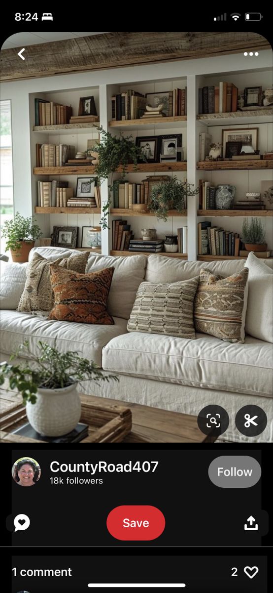 a living room filled with lots of furniture and bookshelves on top of each other