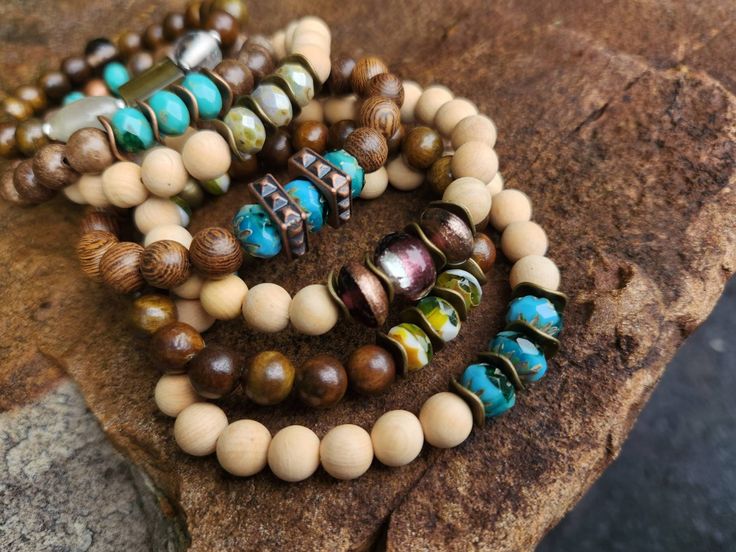 "Czech glass and wood bead stretch bracelets.  Each bracelet is 7¼\".     This listing is for 1 bracelet of your choice." Bohemian Wooden Beads Stretch Bracelet For Meditation, Natural Wood Beaded Bracelets With Round Beads, Wooden Beaded Bracelets With Round Beads, Handmade Wooden Beaded Bracelets For Meditation, Adjustable Wooden Beaded Bracelets With 8mm Beads, Adjustable Wooden Beaded Bracelet With 8mm Beads, Natural Wood Beaded Bracelets, Handmade Beaded Wood Bracelets In Natural Wood Color, Bohemian Wood Beaded Bracelets