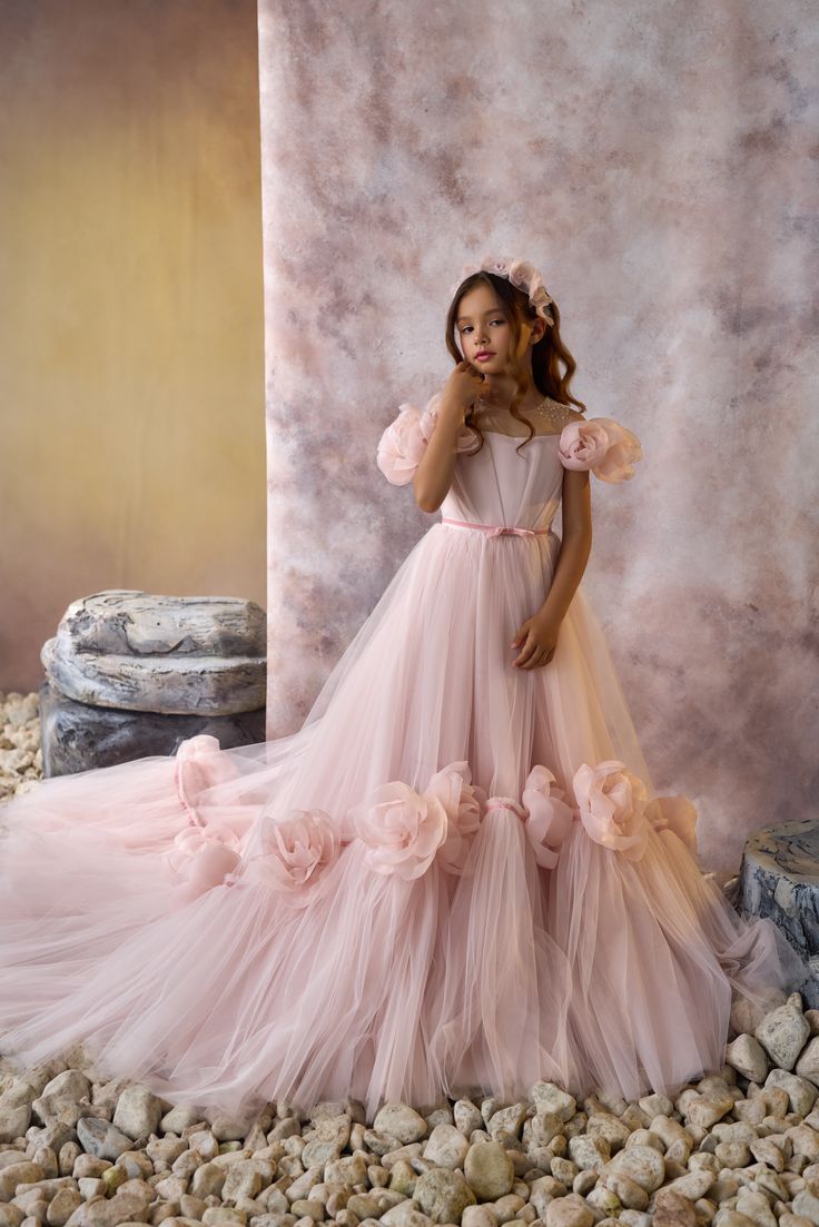 This magnificent Pentelei Couture Flower Girl Dress, the epitome of elegance and grace for your little princess! This exquisite children's formal wear features an off the shoulder design adorned with a cluster of hand rolled roses on the sleeves, creating a delicate and whimsical look. The sheer neckline adds a touch of sophistication, while the voluminous tulle skirt with a train in the back will make your child feel like a true royalty. Each detail of this dress is carefully crafted, from the Toddler Wedding Dress, Dresses Boutique, Wedding Dresses For Kids, Flower Girls Dresses, Princess Flower, Princess Skirt, Dresses For Kids, Communion Dresses, Illusion Neckline