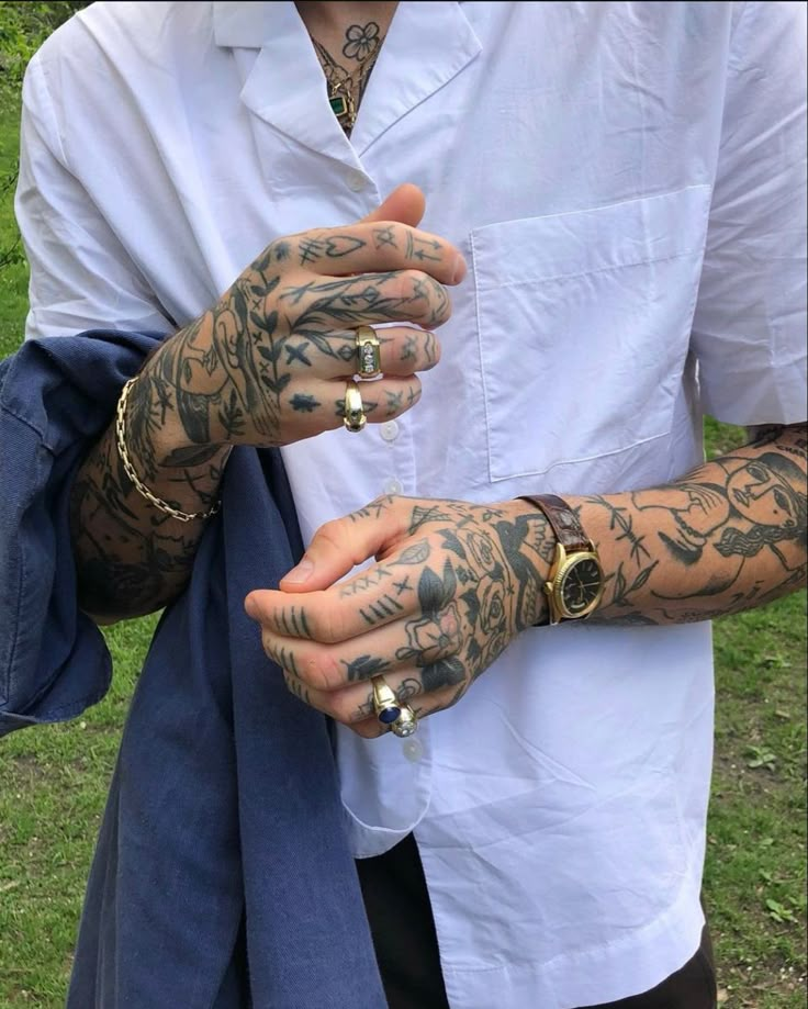 a man with tattoos on his arms and hands