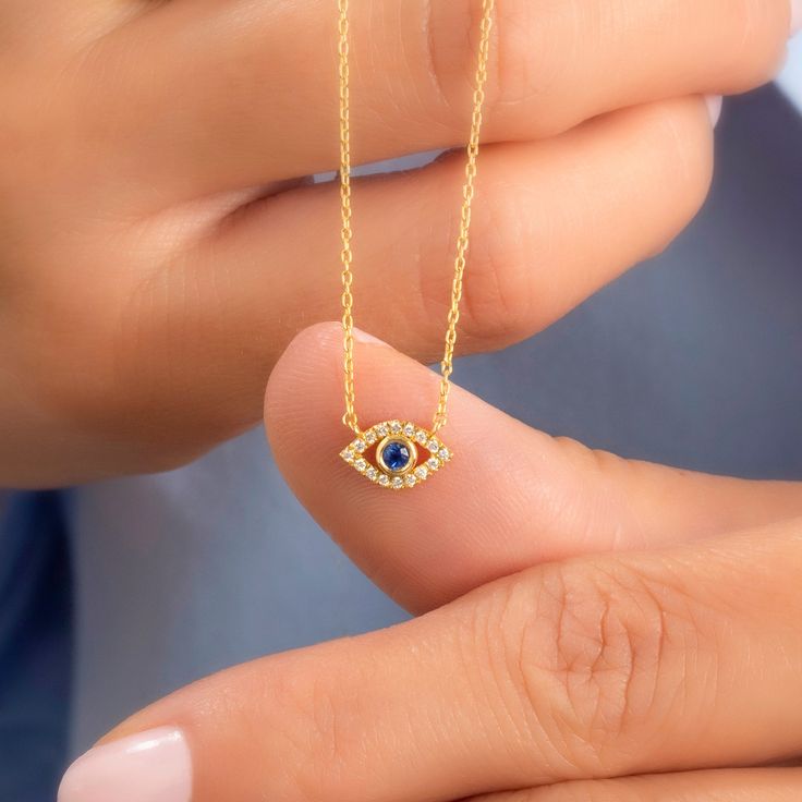 14k Gold and diamond evil eye necklace with sapphire, ruby and emerald center stone options.  Please leave a note with your order to specify your choice of stone. You can choose from sapphire, ruby or emerald.  Stone: Natural Diamond Diamond: 0. 10 ct diamond Charm Measurements: 10 mm x 5 mm ( 0. 4 inch. x 0. 5 inch ) Chain: 1. 1 mm link chain Chain Length: 14+2, 16+2, 18+2 options or any length up to 20 inches without extension. (Please leave a note for the chain length) Color: G  Quality: SI-V Black Friday Jewelry, Necklace Sapphire, Necklace Evil Eye, Diamond Evil Eye, Forever Jewelry, Necklace Diamond, Gold Diamond Jewelry, Diamond Charm, Jewelry Ring Box