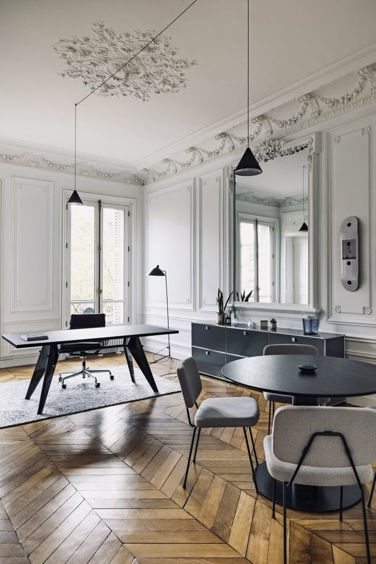 an elegant dining room with white walls and wood floors