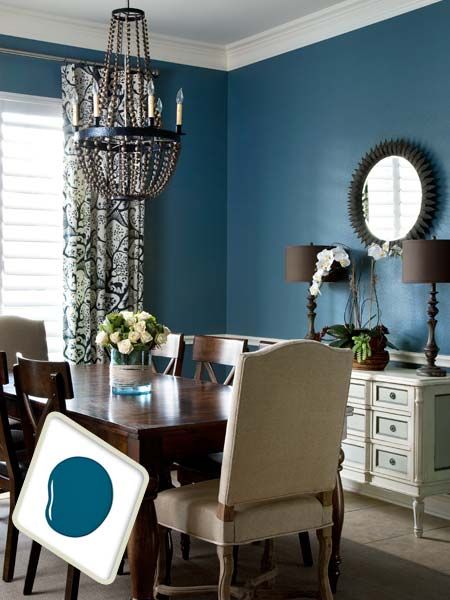 a dining room table with chairs and a chandelier