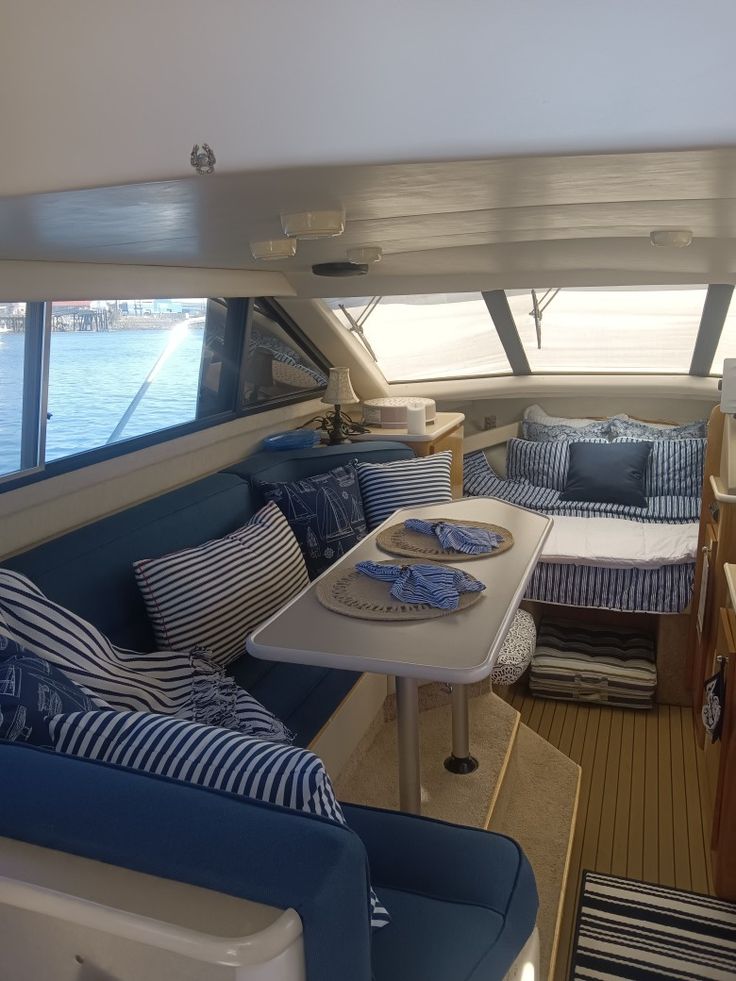 the interior of a boat with blue and white decor