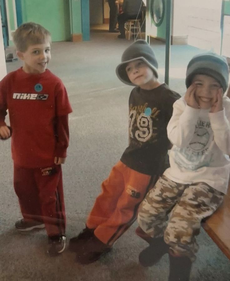 three young boys standing next to each other