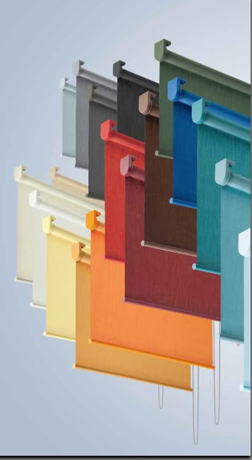 an assortment of different colored blinds hanging from hooks