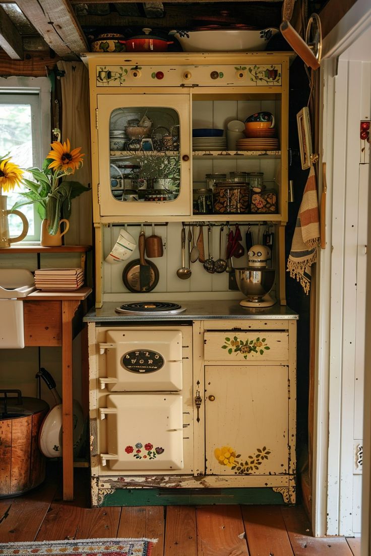 an old fashioned kitchen with sunflowers on the window sill and antique stove