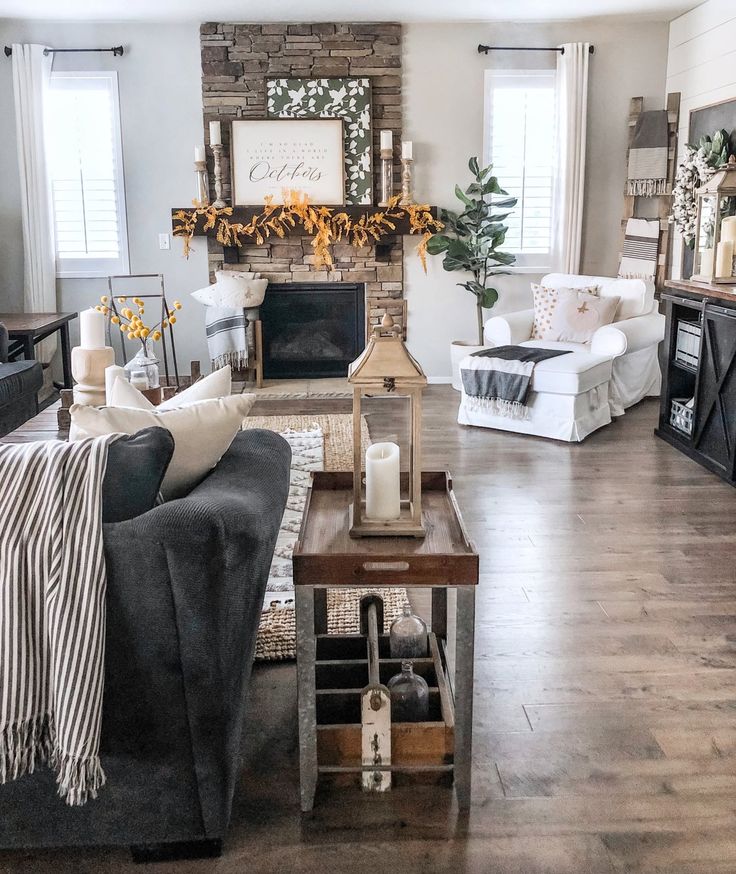 a living room filled with furniture and a fire place in the middle of the room