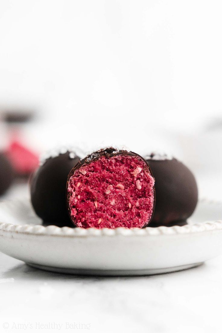 two chocolate covered candys on a white plate