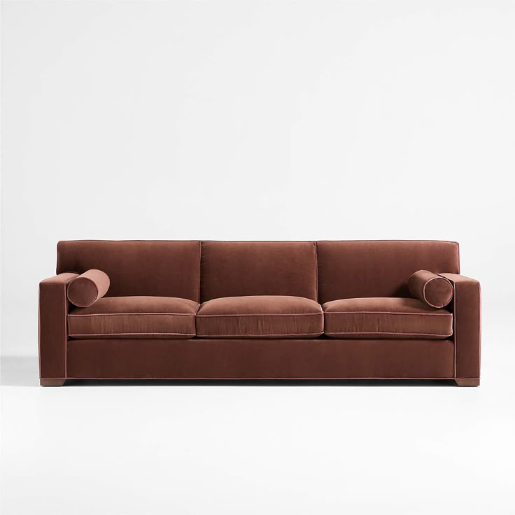 a brown couch sitting on top of a white floor