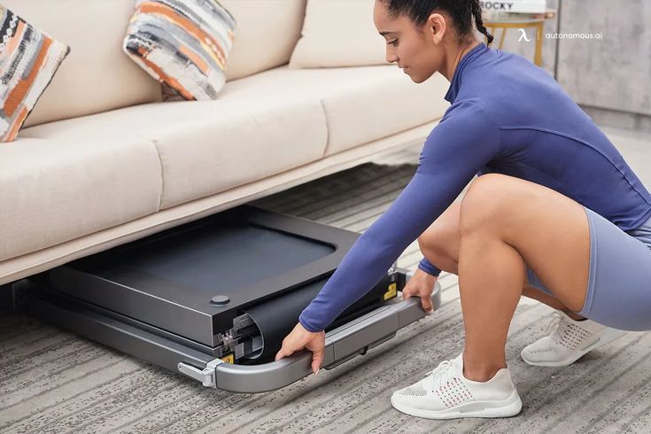 a woman squatting on the floor next to an open luggage bag and looking at it