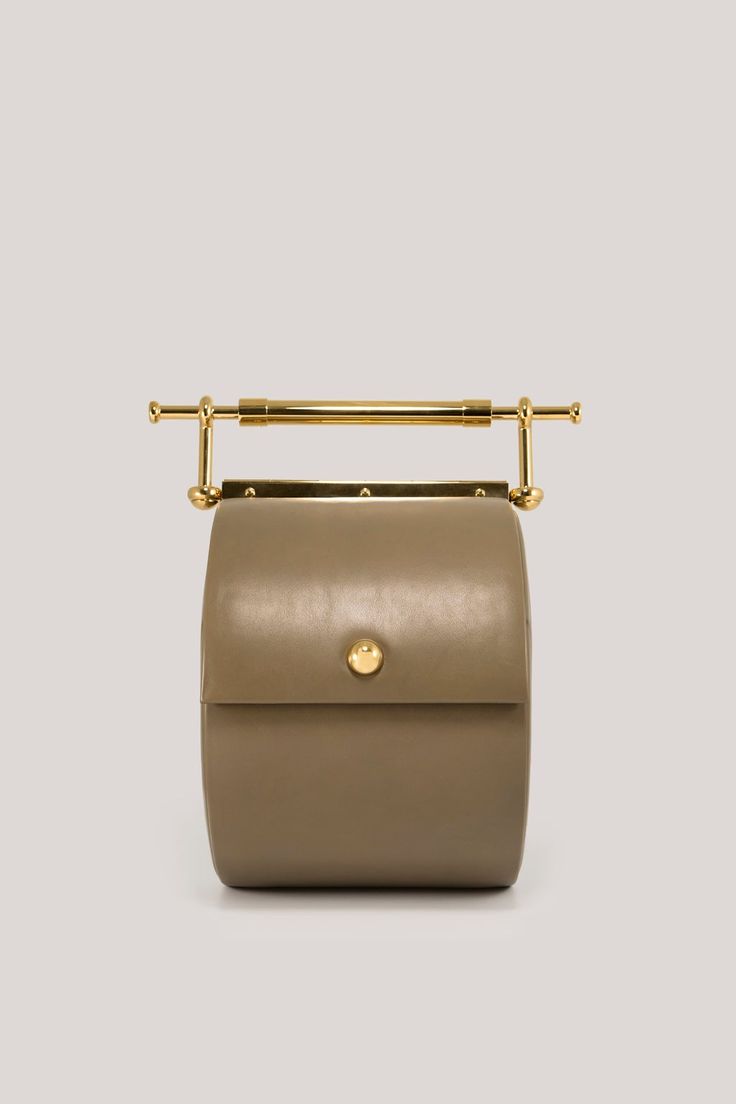 Thana Caccia – daana saakena Designer Shoulder Bag With Gold-tone Hardware And Round Handle, Designer Bag With Gold-tone Hardware And Round Handle, Designer Bags With Gold-tone Hardware And Round Handle, High-end Gold Box Bag With Top Carry Handle, Luxury Beige Shoulder Bag With Brass Hardware, Modern Bucket Shoulder Bag With Brass Hardware, Luxury Bucket Bag With Handle Drop, Luxury Shoulder Bag With Detachable Strap And Round Handle, Luxury Bucket Bag With Top Carry Handle For Business