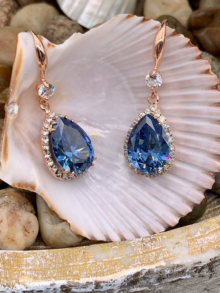 Sapphire blue cubic zirconia accented with diamond cubic zirconia earrings Blue Diamond Drop Earrings With Prong Setting, Formal Blue Pear-shaped Diamond Earrings, Evening Sapphire Earrings With Diamond Accents, Sapphire Earrings With Diamond Accents For Evening, Blue Sapphire Pear-shaped Earrings, Evening Earrings With Sapphire And Diamond Accents, Blue Teardrop Earrings With Prong Setting, Blue Diamond Earrings For Evening, Blue Pear-shaped Diamond Earrings For Anniversary