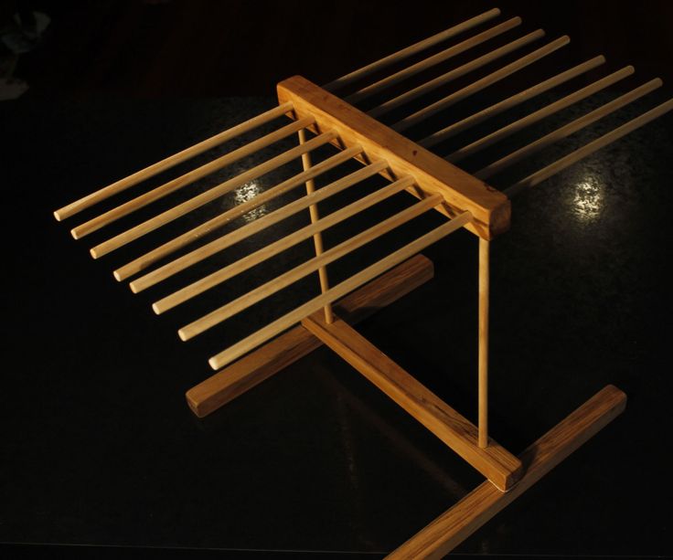 a wooden bench sitting on top of a black table