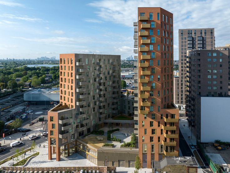 two tall buildings with balconies on top of them in the middle of a city