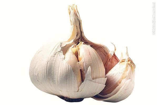 two bulbs of garlic on a white background