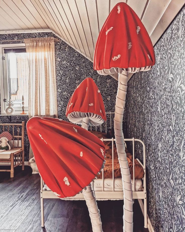 two red lamps sitting on top of a bed in a room with wood flooring