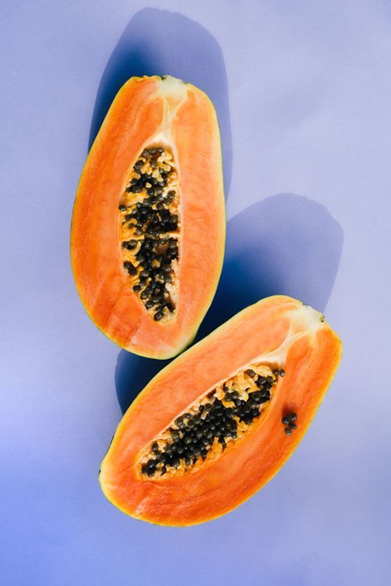 two pieces of papaya on a blue background