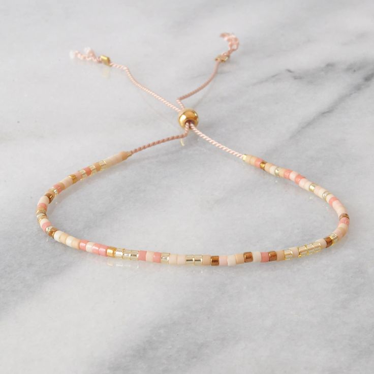 "Sweet delicate beaded bracelets are the perfect gift. (And yes, self-gifting is highly recommended!) Buy more and save more! + style shown in main image: SUNRISE + glass and gold-plated seed beads, on blush silk cord + adjustable from 5\" - 9\" + sliding bead makes for easy on/off design + finished with gold filled crimps that won't tarnish + all Libby & Smee beaded bracelets come packaged on a logo card in a clear resealing bag for storage and gift giving EXCLUSIVE STYLES ARUBA: teal, turquois Dainty Adjustable Friendship Bracelets With Round Beads, Adjustable Beige Beaded Bracelets With Tiny Beads, Adjustable Beige Beaded Bracelet With Tiny Beads, Dainty Adjustable Hand-strung Beaded Bracelets, Adjustable Beige Friendship Bracelets As A Gift, Adjustable Beige Beaded Bracelet As A Gift, Beige Bracelet With Sliding Knot As Gift, Adjustable Beige Beaded Bracelets With Colorful Beads, Beige Sliding Knot Bracelet For Gifts