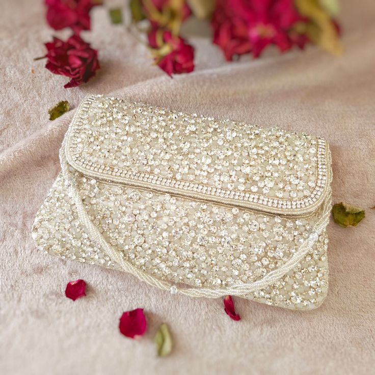 Featuring a Silver Clutch bag in cotton base with a flap opening with a embroidererd strap, Handcrafted with Intricate Pearl, beaded crystal and rhinestones.  Perfect for evening parties and a special ocassion.  This item made of is 100% handwork We try to take pictures as normal as we can but colors may slightly vary due to different lighting setups. Please note: No Returns No Exchange. But If you have any issue with your order, Kindly contact us before leaving a review Bridal Clutch Purse, Juliet Rose, Silver Clutch Bag, Bridal Clutch Bag, Zardosi Work, Zardozi Work, Wedding Handbag, Embellished Clutch, Silver Clutch