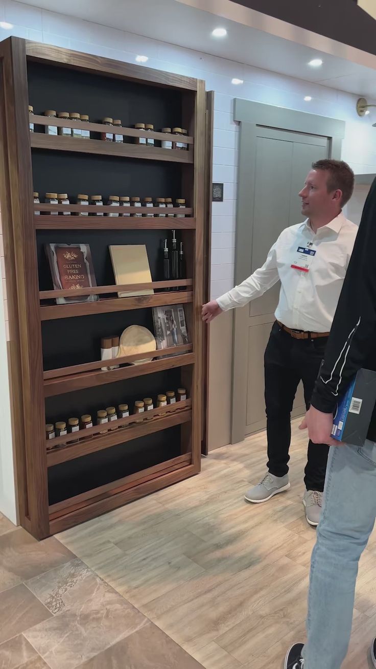 two men standing in front of a display case