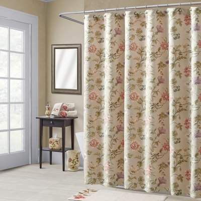 a shower curtain with flowers on it in a bathroom