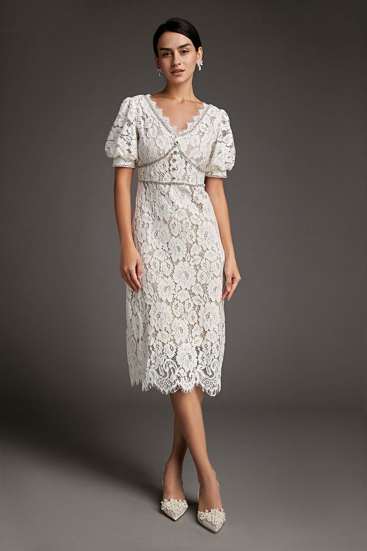 This lace crochet V-neckline midi dress will fill any of your little white dress needs, from your bridal shower to your after party. The textured lace overlay, accented with thick embroidery that outlines the lace’s blooms. Also features puff sleeves and delicate scalloped eyelash lace hem. The rhinestone trim and buttons adds an extra glitz and glam. No Stretch Medium Weight Size runs small,recommend one size up Fabric: 100% Polyester,Lining: 100% Polyester Model is 174cm/5'7" tall, 81cm/32" bust, 61cm/24" waist and 90cm/35" hip and wears a size S. Care Instruction: Hand Wash, Do not bleach, Dry flat in shade, Iron cool (max 110â„?, Dry clean, tetrachloroethylene(PCE) only.Please note: The images represent actual product though color of the image and product may slightly differ. This item Wedding Guest Dresses Formal, Midi Dress Wedding, Thick Embroidery, Modest Midi Dress, Vintage Dress Design, Dresses Wedding Guest, Little White Dress, Cap Dress, Rhinestone Trim