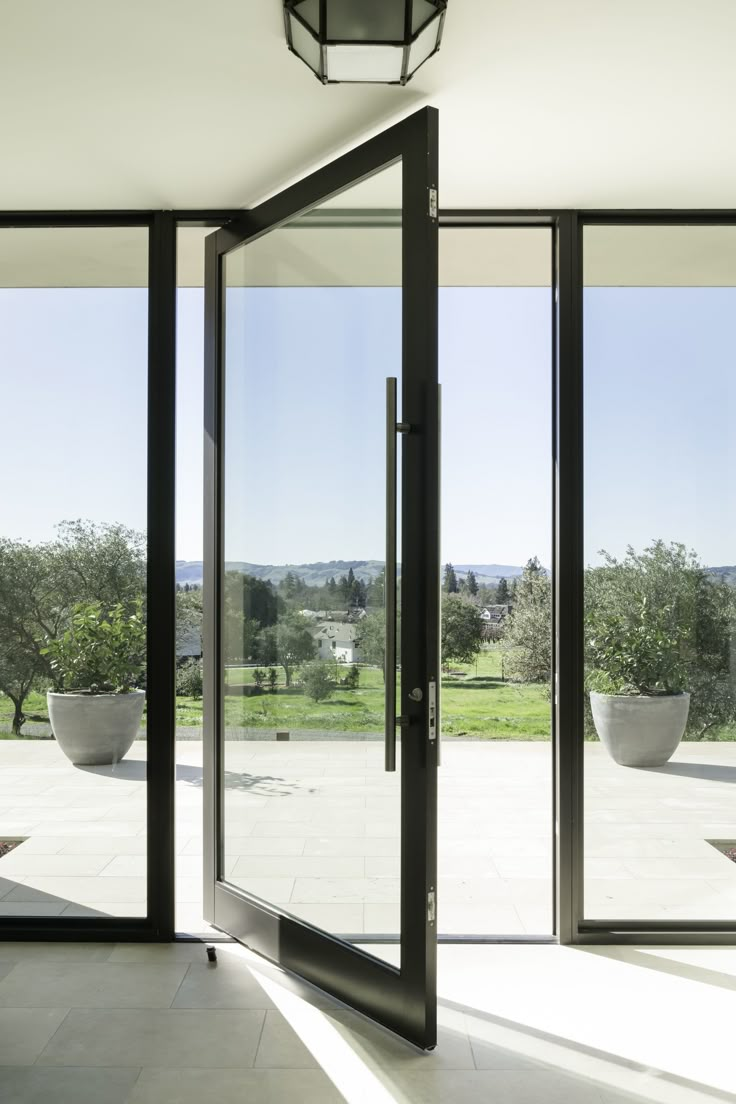 an empty room with large glass doors leading to the outside