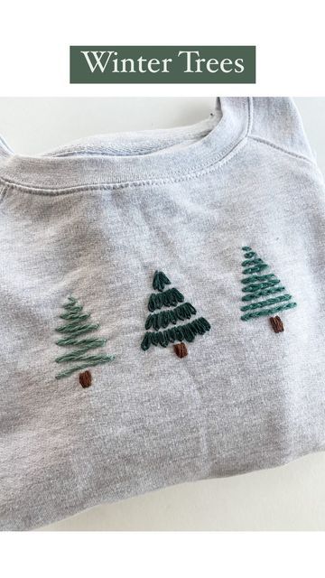 a white shirt with trees on it and the words winter trees written in green ink