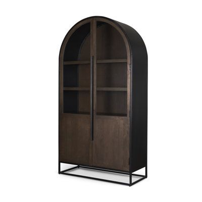 an arched wooden bookcase with metal legs