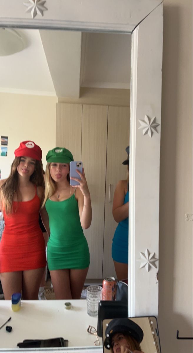 two women in bathing suits taking selfies in the mirror