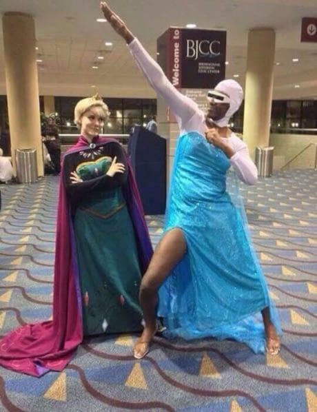 two people dressed up as disney and princesses posing for a photo in an airport