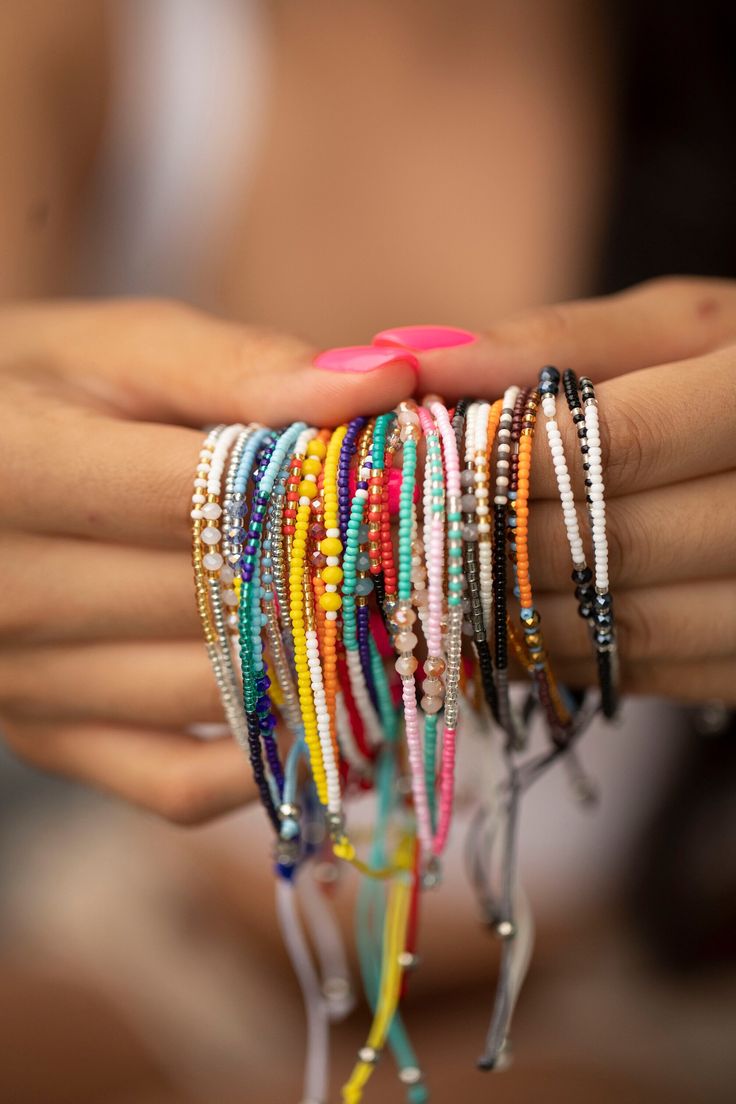 These bracelets are so cute and colorful, sure to give a pop of color to any look. They give a boho vibe and look great dressed up or down. Stack or wear alone. We have so many cute styles, and they makes the perfect gift! Details:       12 styles     Each stack comes with 3 rows of beads     Size is adjustable (7" - 9")     Materials:     Nylon with beads Stacked Boho Bracelets, Bohemian Bracelets For Friendship In Summer, Trendy Hand Wrapped Beaded Bracelets For Friendship, Trendy Multicolor Friendship Bracelets For Festivals, Pink Braided Bracelets With Colorful Beads For Festival, Hippie Friendship Bracelets With Colorful Beads, Pink Braided Bracelet With Colorful Beads For Festival, Colorful Beaded Bohemian Friendship Bracelets, Pink Adjustable Beaded Hippie Bracelet