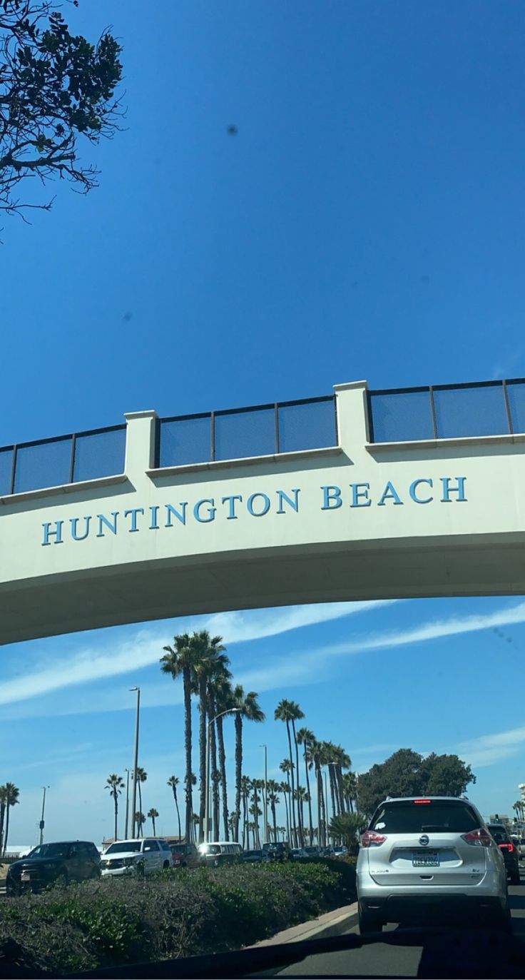 cars are driving under an overpass with the words huntington beach on it's side