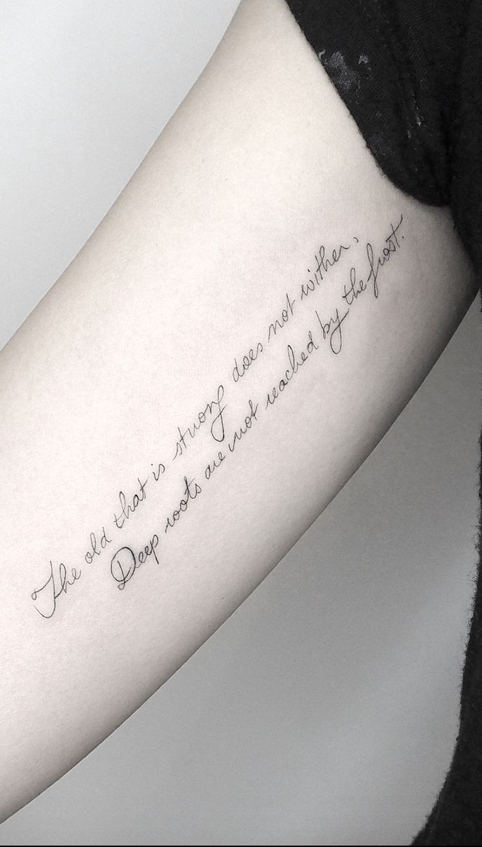 a woman's arm with a quote written in cursive writing on it