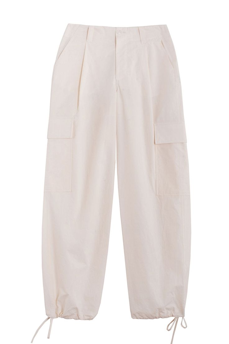 Loosely tailored cargo pant in a soft yet structured cotton. Straight leg with tie at ankle, cinch for a more tapered silhouette. Side pockets and oversized patch pockets above knee. Made in New York City. Fabric is 100% cotton. Ella is 6' tall, 35" bust, 26" waist, 36" hip, and is wearing a size S. Beige Cotton Cargo Parachute Pants, Beige Cotton Parachute Pants With Patch Pockets, Utility Ankle-length Cargo Pants, Beige Wide-leg Cotton Cargo Pants, Beige Cotton Parachute Pants With Side Pockets, Beige Cotton Parachute Pants With Belt Loops, Cotton Straight Cargo Pants With Flap Pockets, Straight Cotton Cargo Pants With Flap Pockets, Cotton Cargo Jeans With Belt Loops For Work