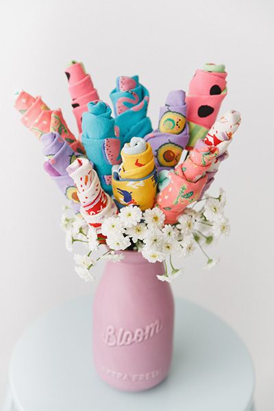 a pink vase filled with lots of toys