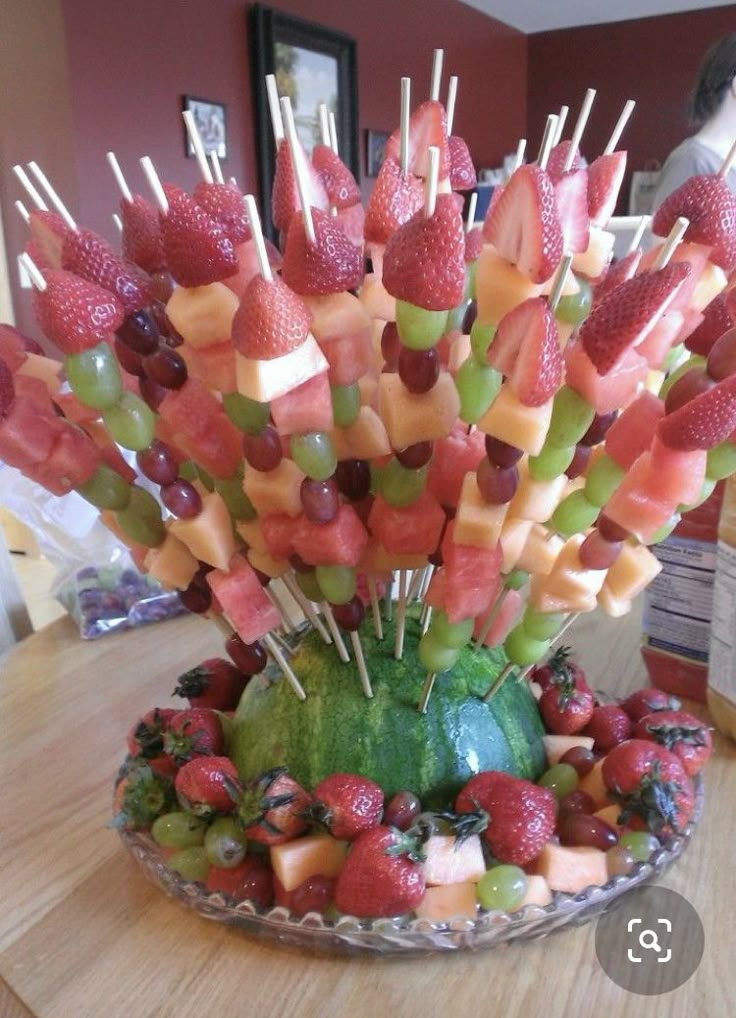 a bowl filled with fruit on top of a wooden table