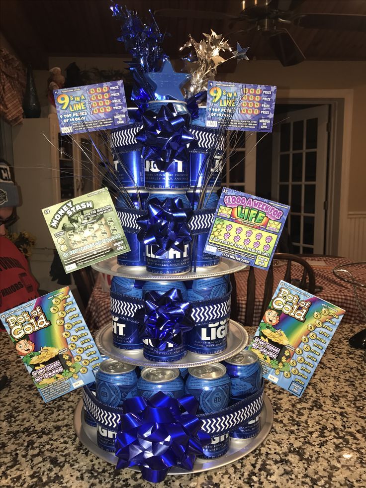 there is a cake made out of cans and blue ribbons on the bottom tier,