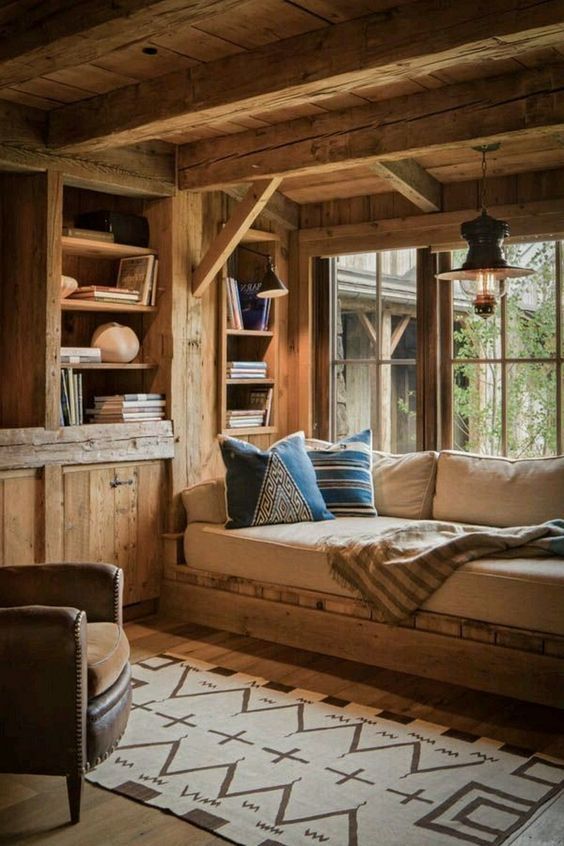 a living room filled with furniture and wooden walls