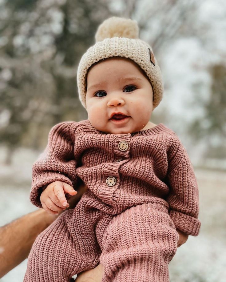 This adorable Jumpsuit, named the Harper Jumper, has add on options for matching booties and beanie and bow! Crafted from chunky, soft yarn, this outfit ensures both warmth and style for your newborn. Our Beige Beanie matches well with Plum Harper! The Harper Jumpsuit is a must-have for any baby's fall and winter wardrobe with easy diaper changing double zipper on legs and functioning wooden front buttons. Features: 100% cotton, wooden buttons, metal zipper Take-home baby outfit Welcome home outfit Newborn photography sessions Product Details: Material: 100% Cotton Care Instructions: Hand wash or machine wash on a gentle cycle with cold water. Lay flat to dry; avoid direct sunlight. Do not bleach; use a low heat iron if needed. Newborn Winter Outfits, Welcome Home Outfit, Newborn Hospital Outfits, Beige Beanie, Sweater Romper, Winter Newborn, Hospital Outfit, Winter Photos, Knit Jumpsuit