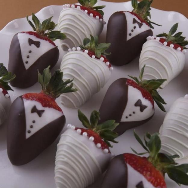 chocolate covered strawberries are arranged on a white plate