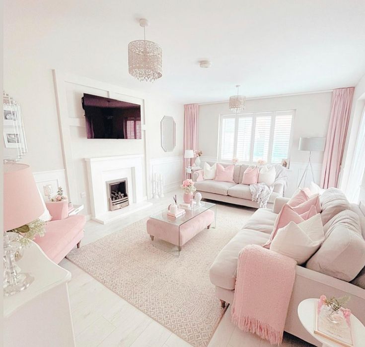 a living room filled with furniture and a flat screen tv mounted on the wall above a fireplace